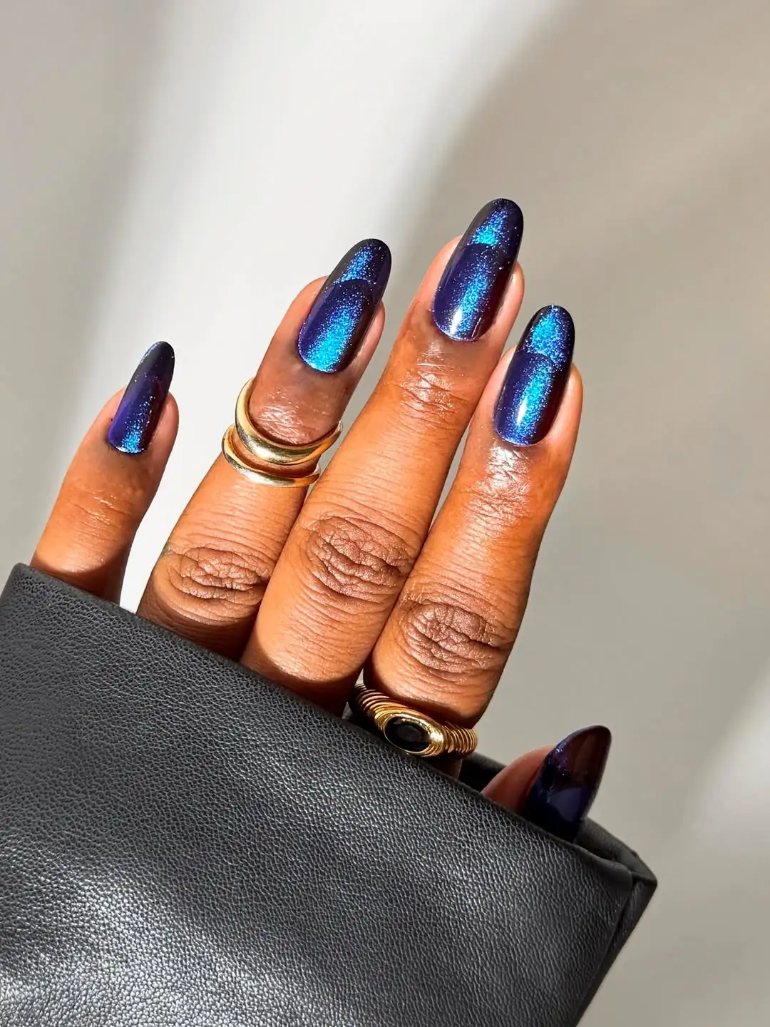 Dark blue cat-eye nails with subtle French tips