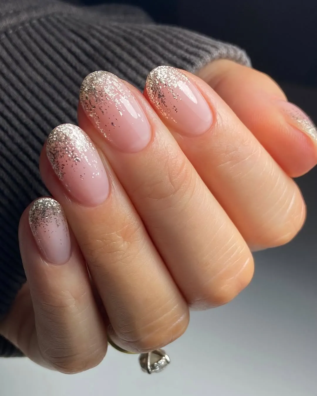 Nude nails with gold glitter ombre French tips