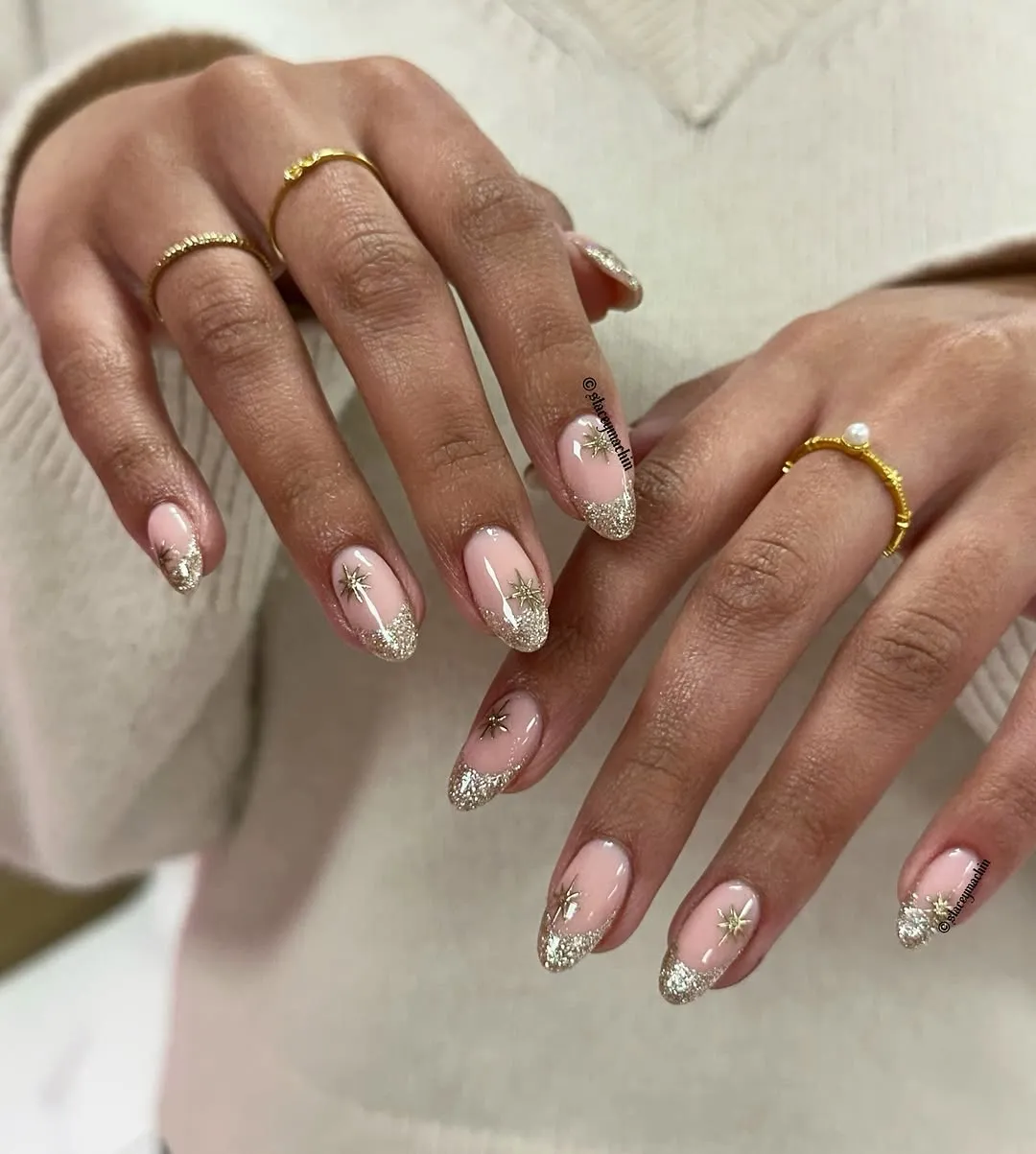 Sparkly gold French tips with gold starburst decals