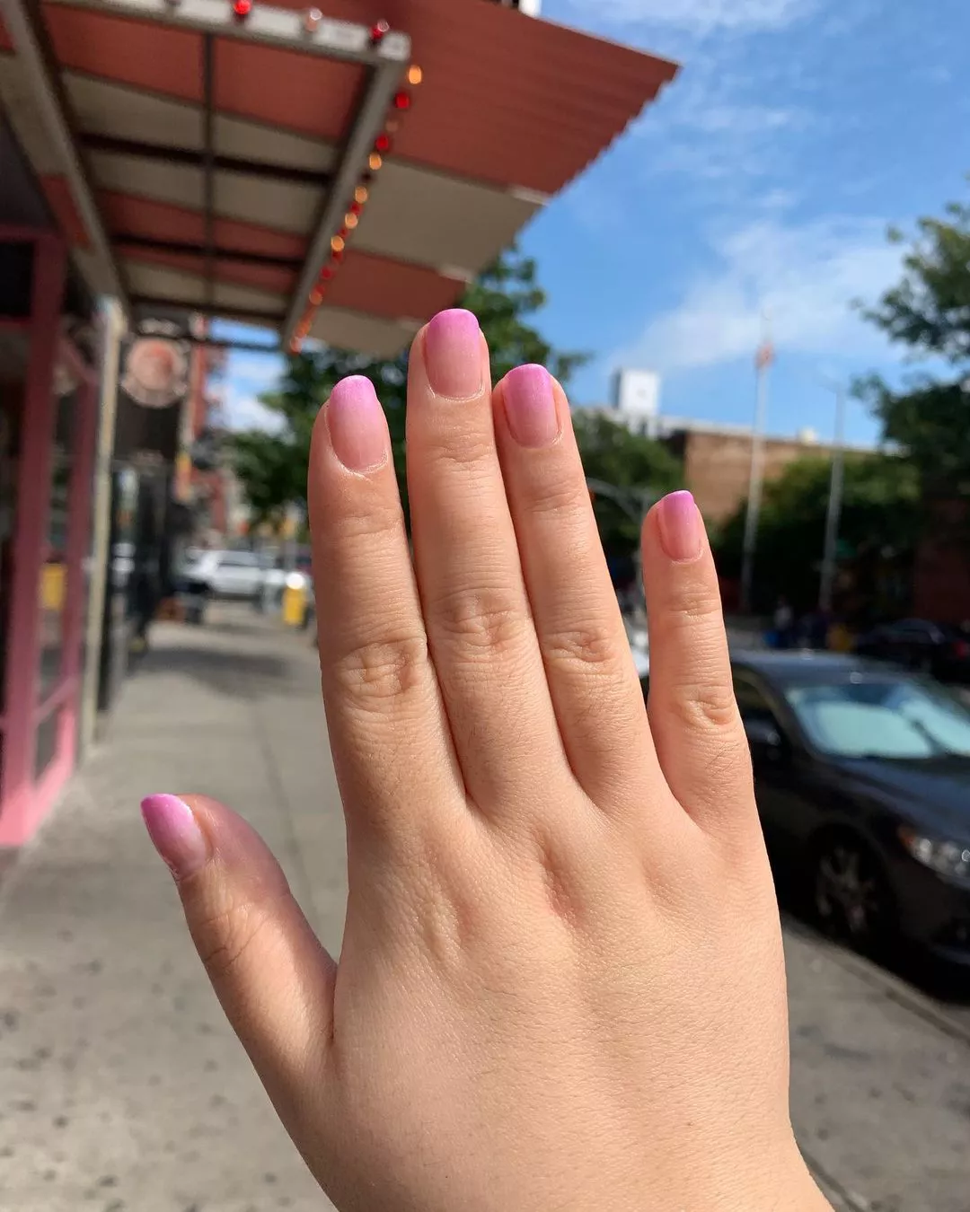 Person with soft pink nails that have a slightly darker pink at the tips
