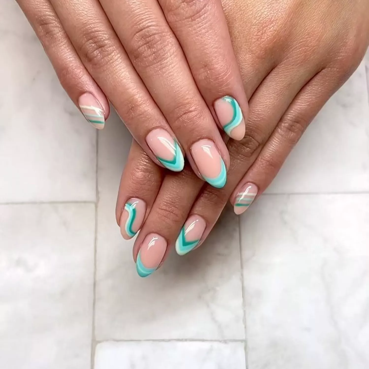 Apex green, mint, and white French manicure with layered wavy accents