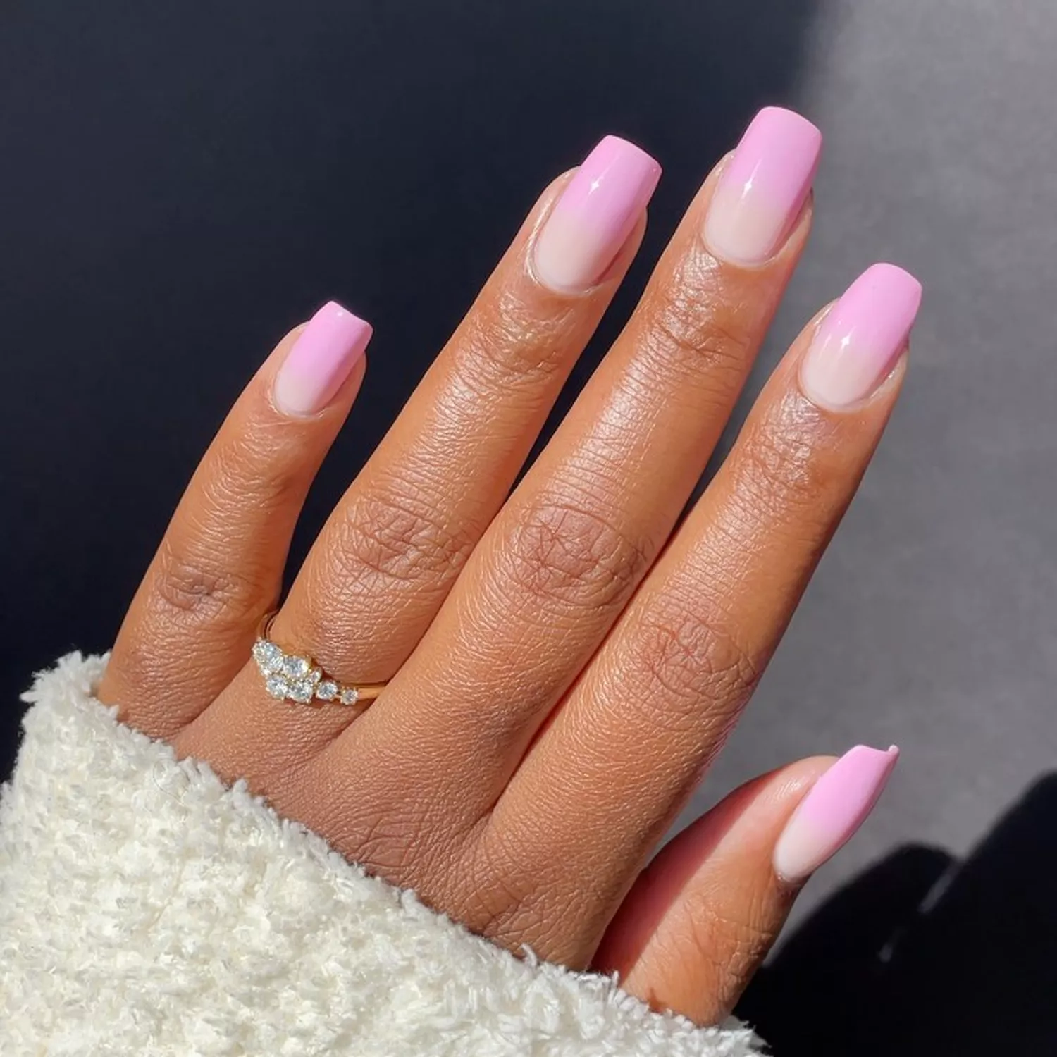 Person with pink French tip nails, with bubble gum pink tips and a light pink base