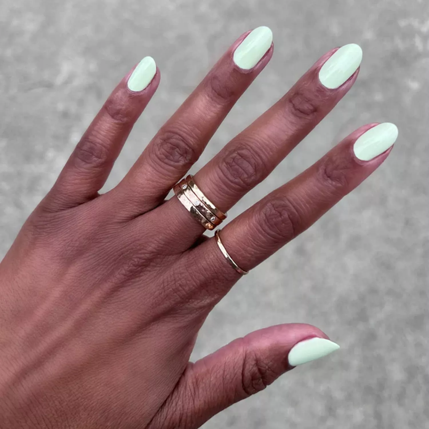 Nails painted with pale Olive & June Corrigan Mint Green Nail Polish 