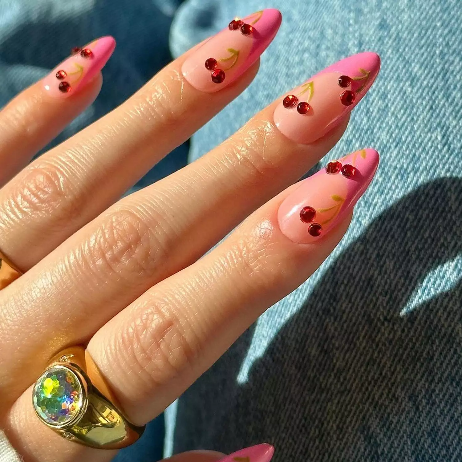 Bubblegum pink French manicure with red rhinestone cherries