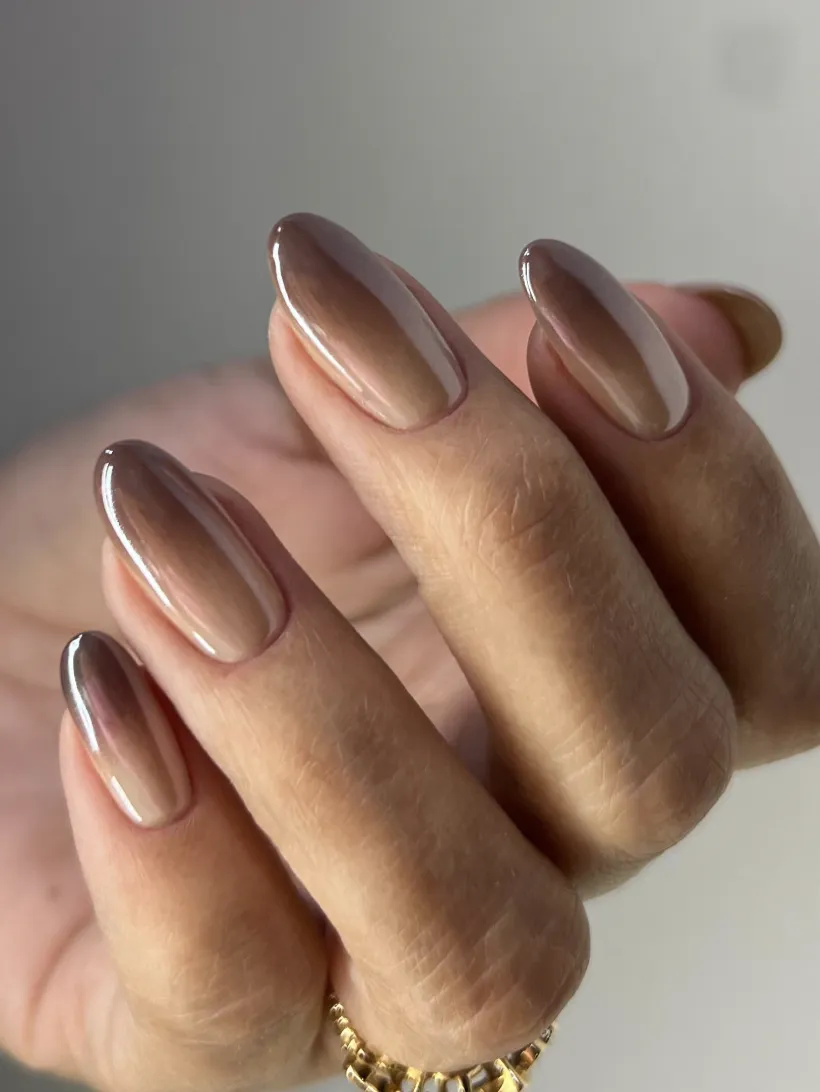 Closeup of fingers with wellmanicured fingernails featuring a shiny finish