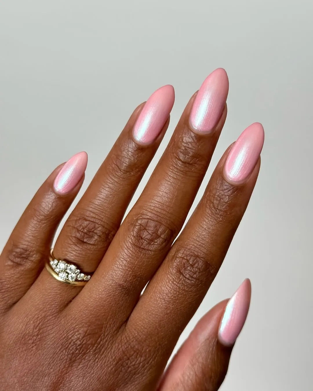 Light pink almond nails with an opalescent finish