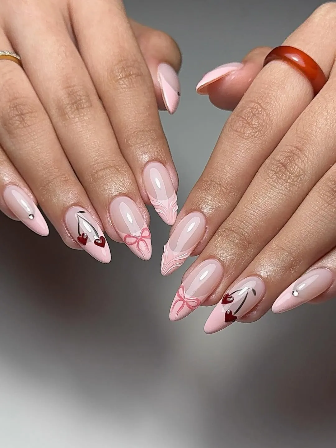 Light pint french nails with bows and cherry designs
