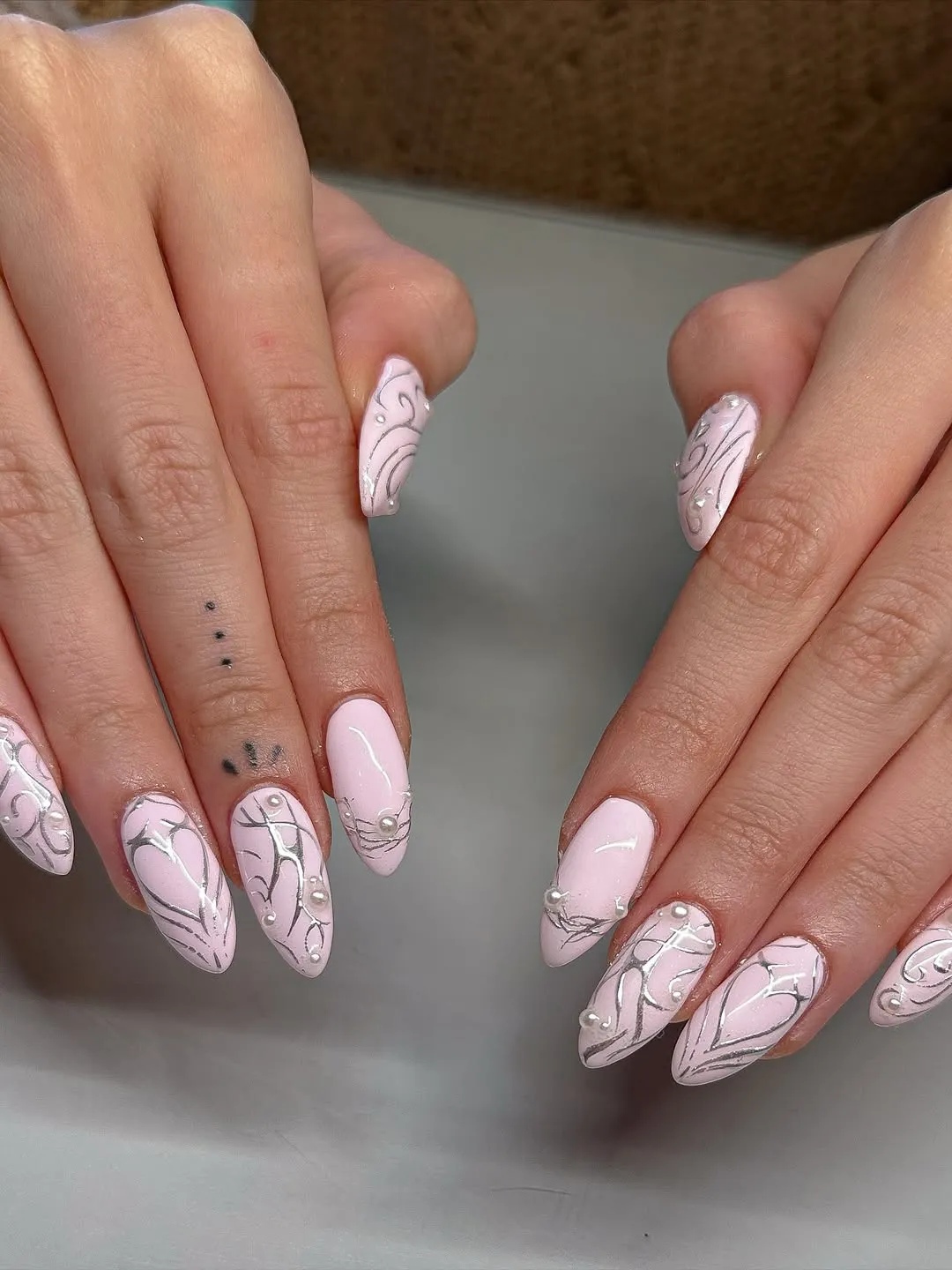Light pink nails with silver designs