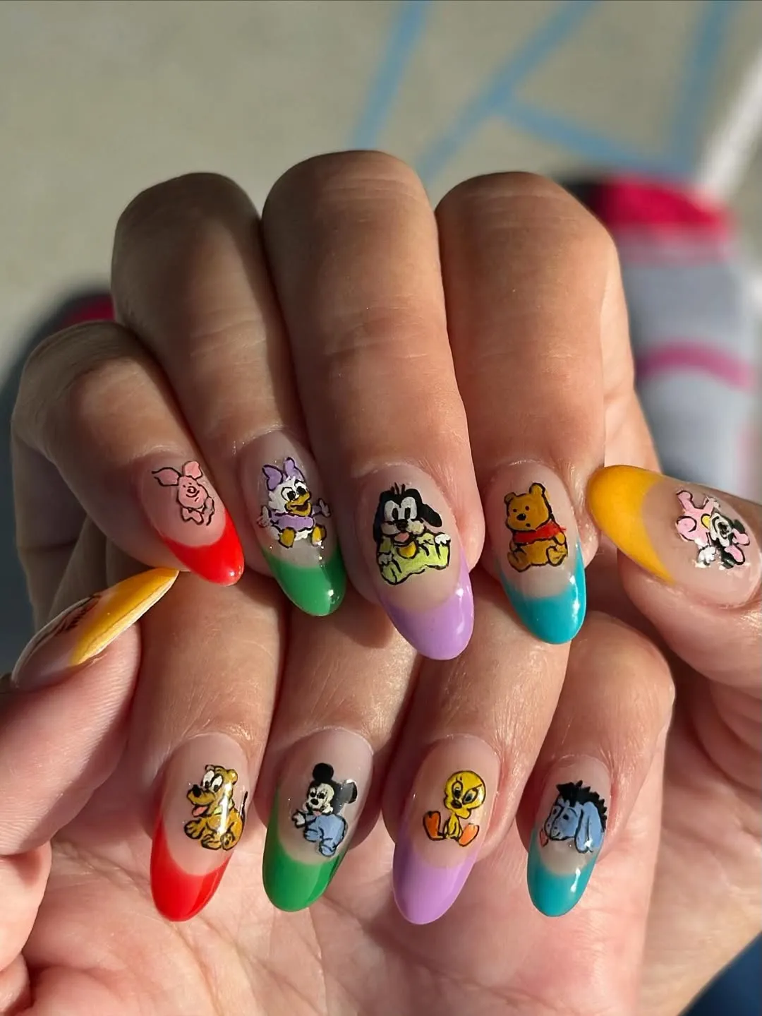 Colorful french tips with baby cartoon characters on each nail