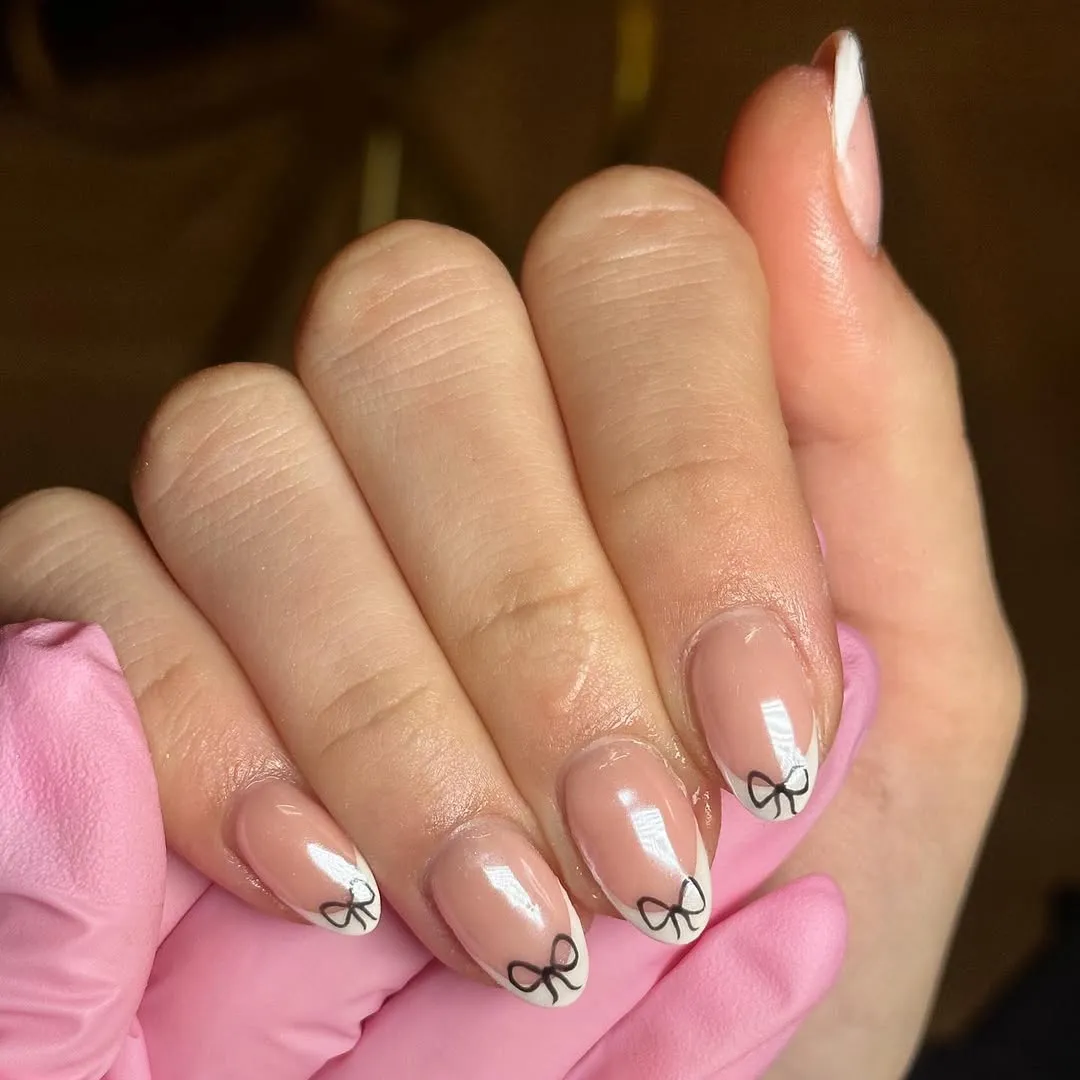 French tips with small black bow on each nail