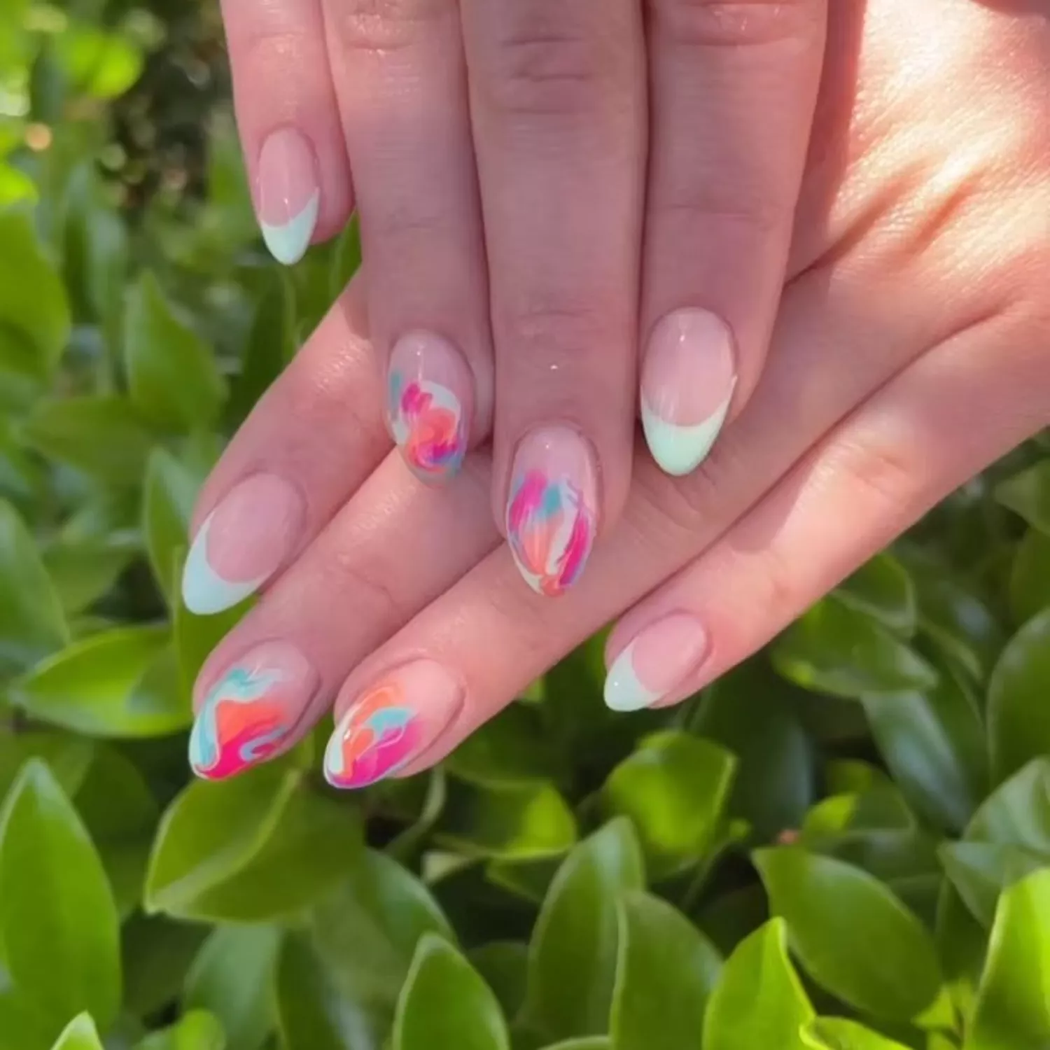 Watercolor French tips with pastel neon yellow-green French tips on almond-shaped nails