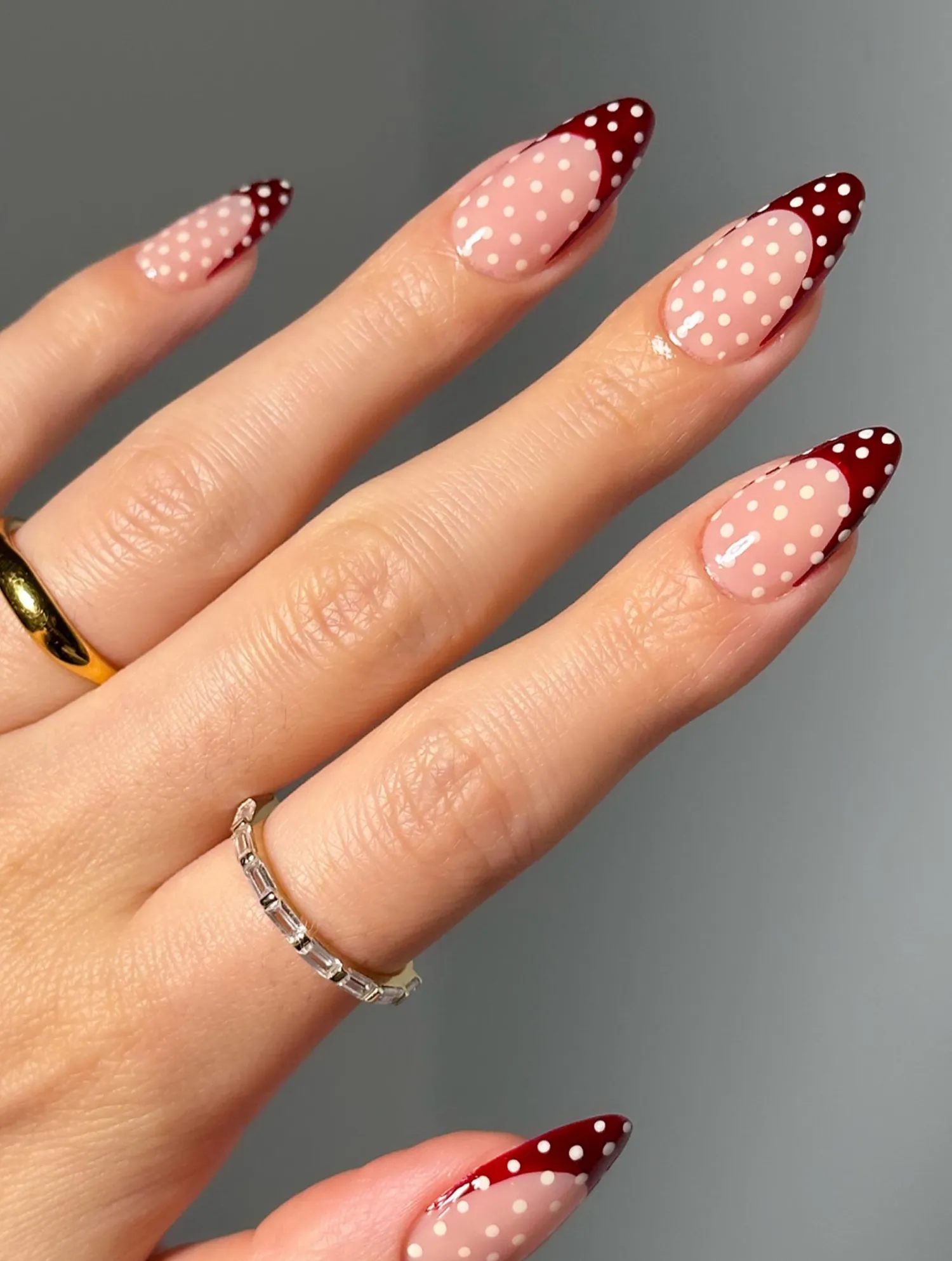Hand with fingernails featuring polka dot nail art