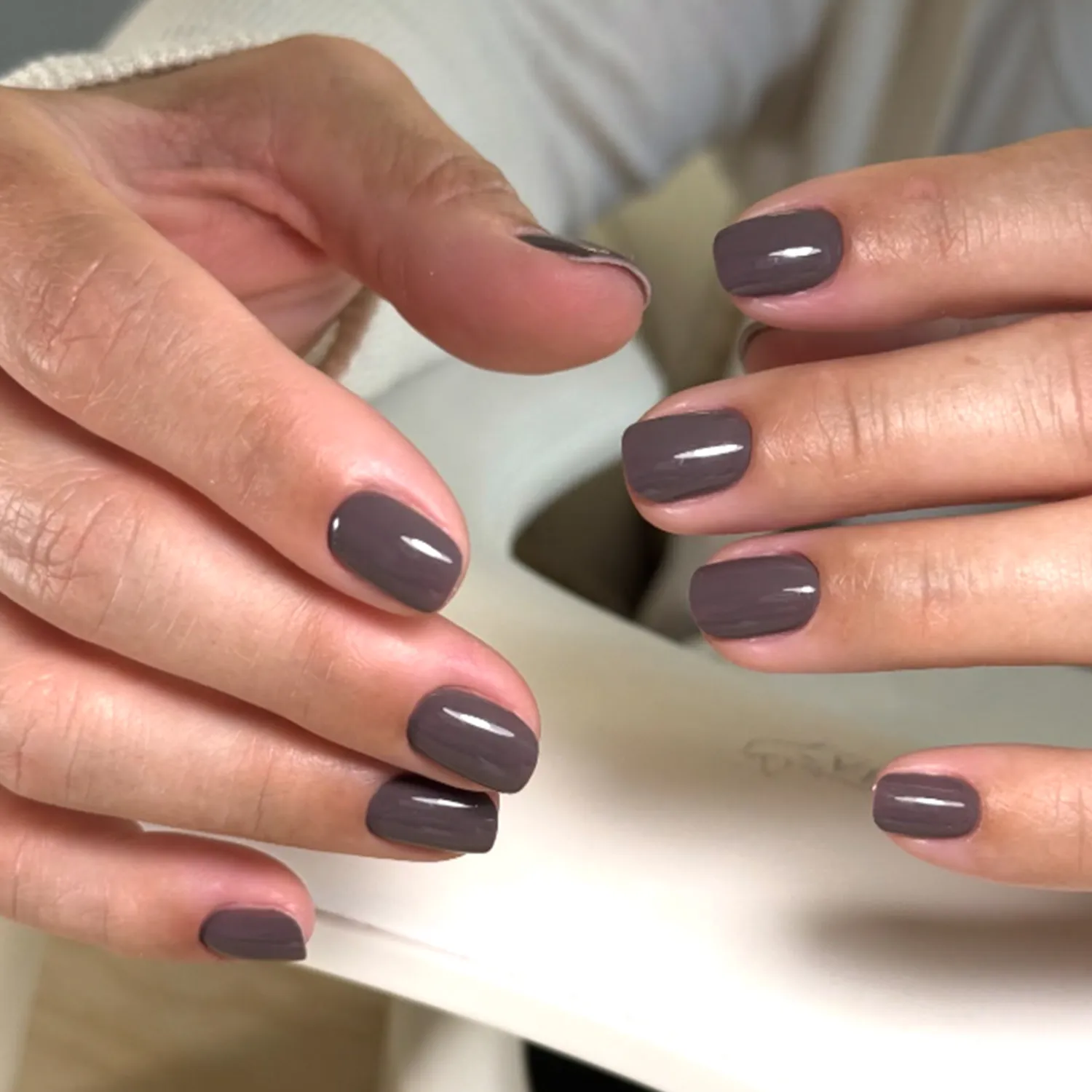 Wellmanicured hands with taupecolored nail polish