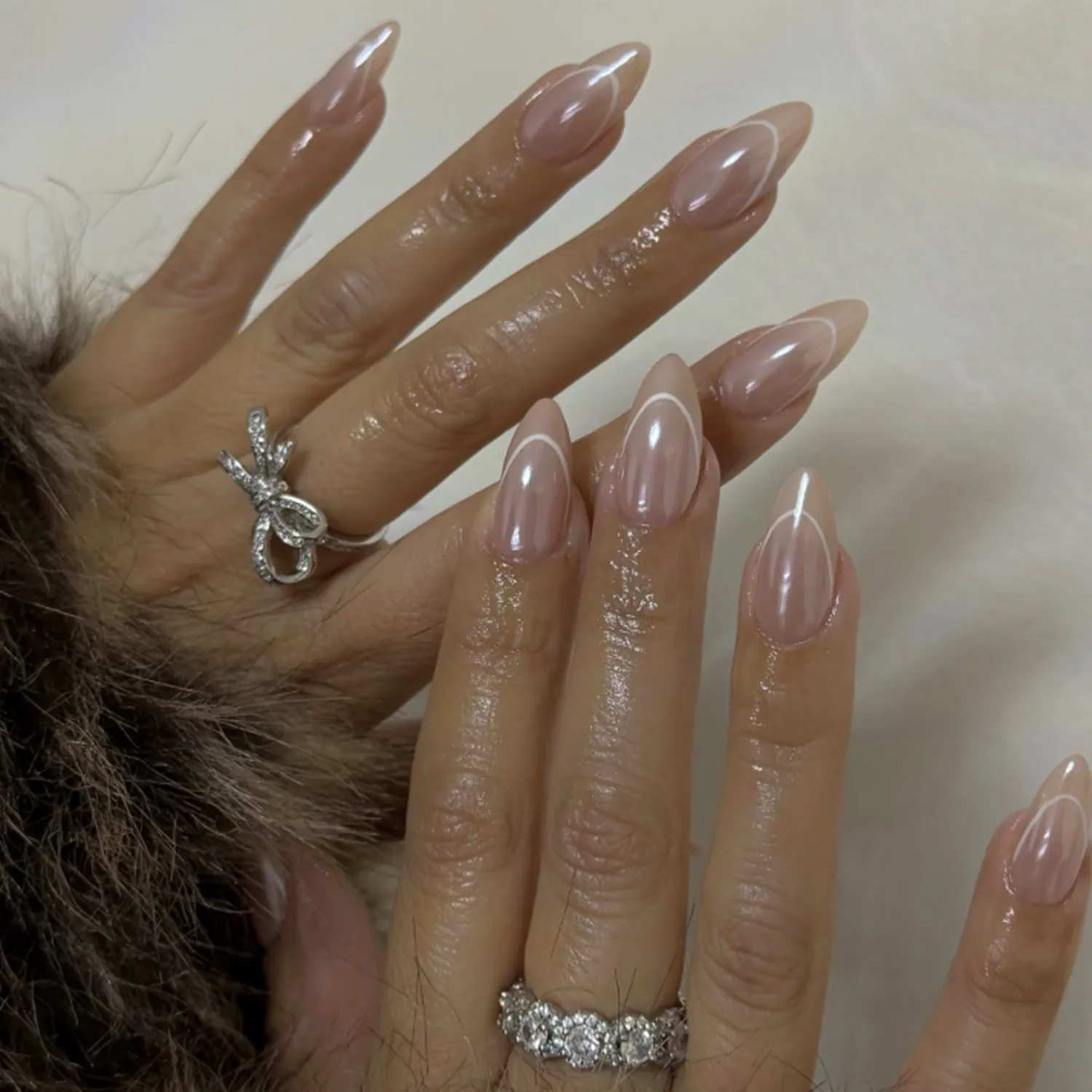 Closeup of manicured hands with polished nails and decorative rings