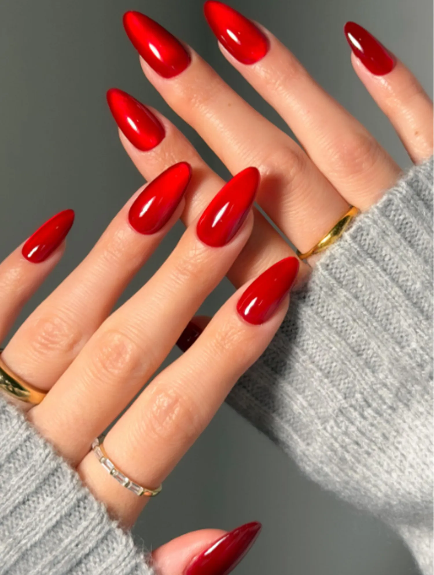 Manicured hands with long polished nails and rings