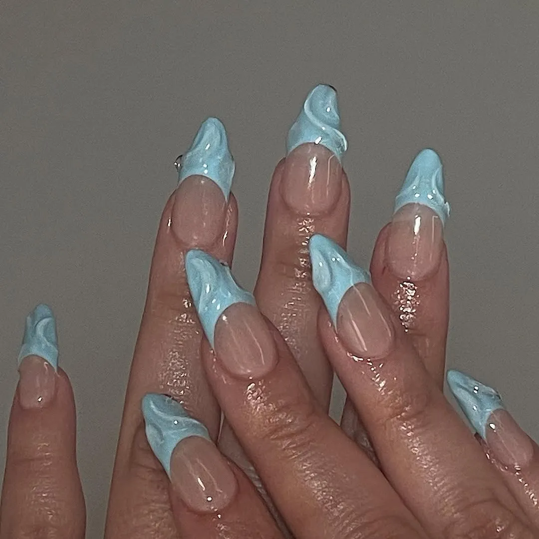 A person showing off a 3D French manicure
