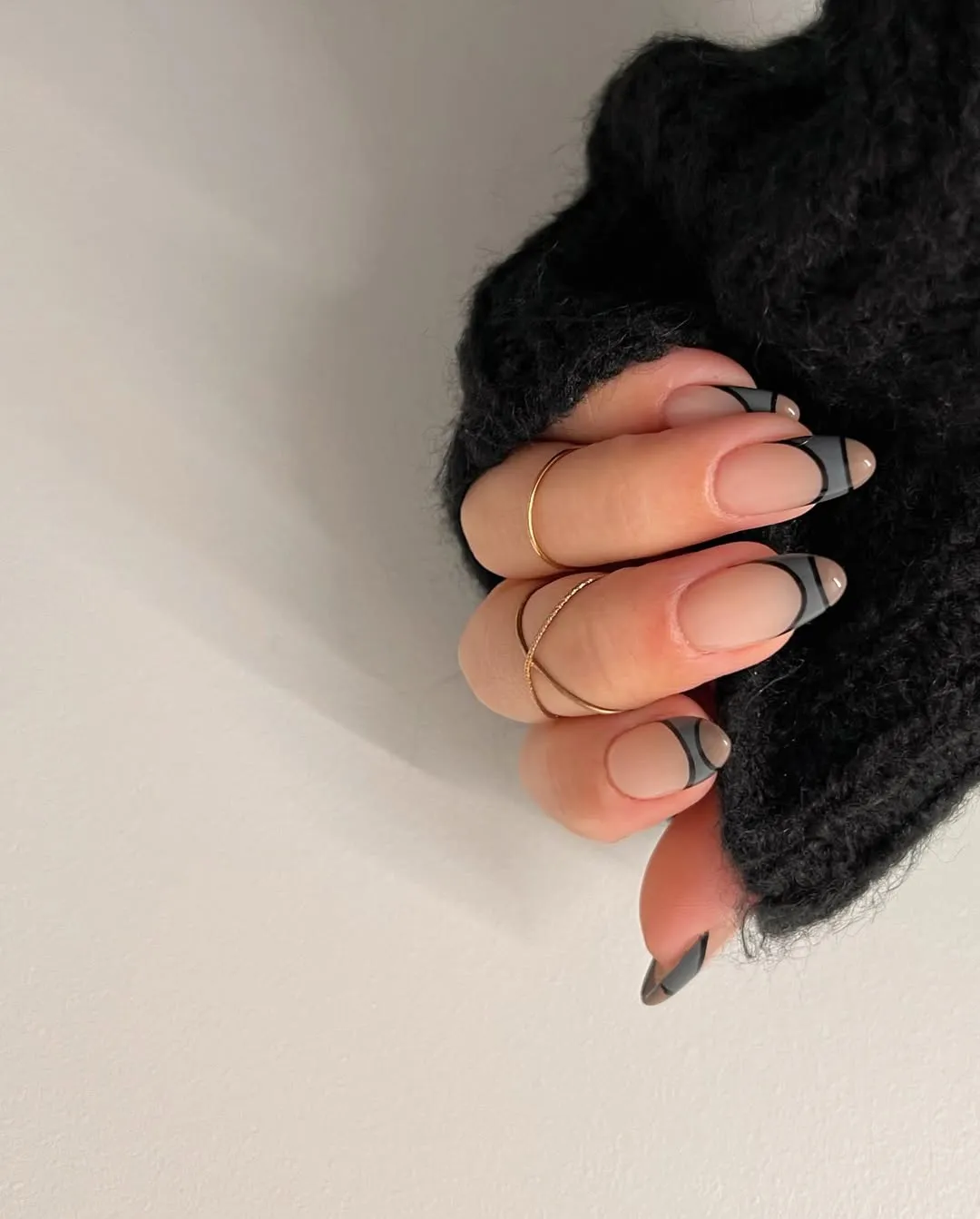 A person showing off a color block manicure