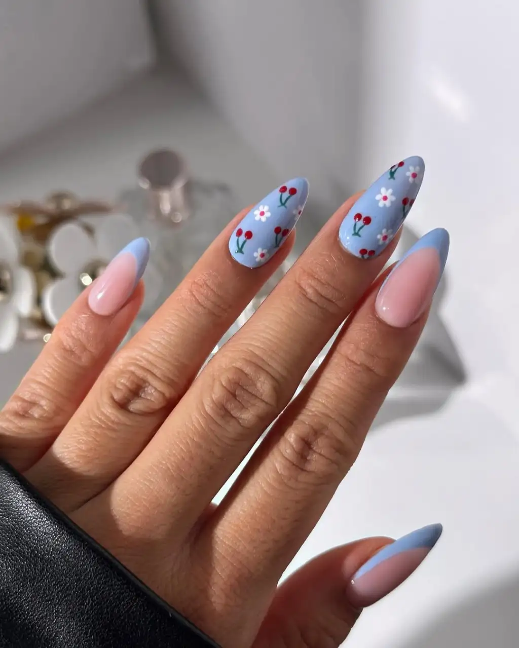baby blue nails with cherry and daisy designs
