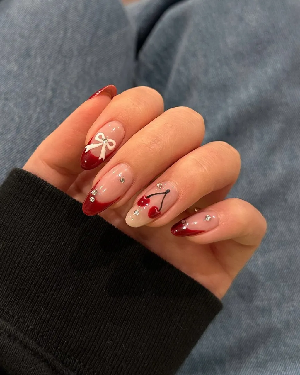 cute dark red french tip cherry nail design with rhinestone accents