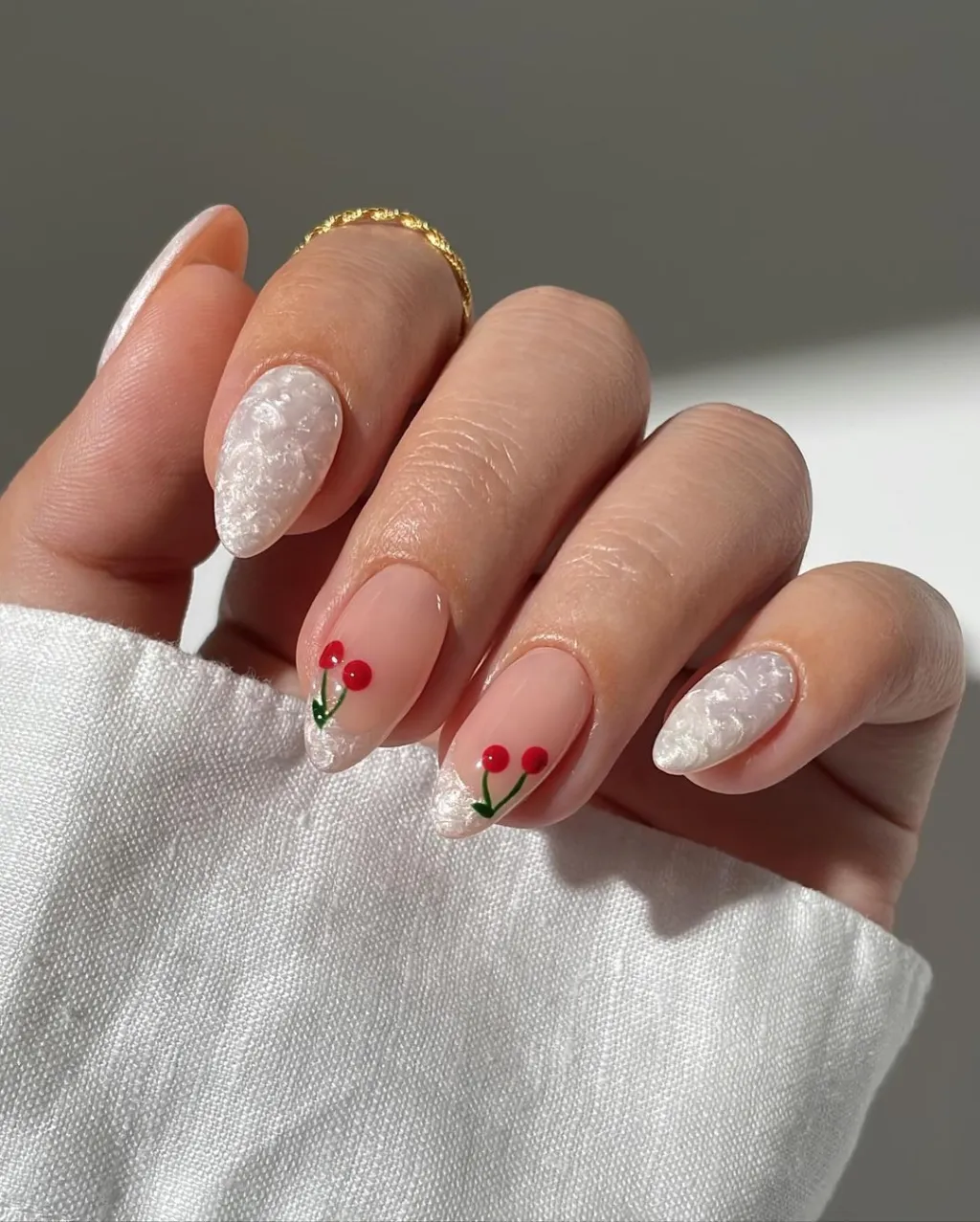 cute red cherry nails mixed with a shimmery holographic white french manicure