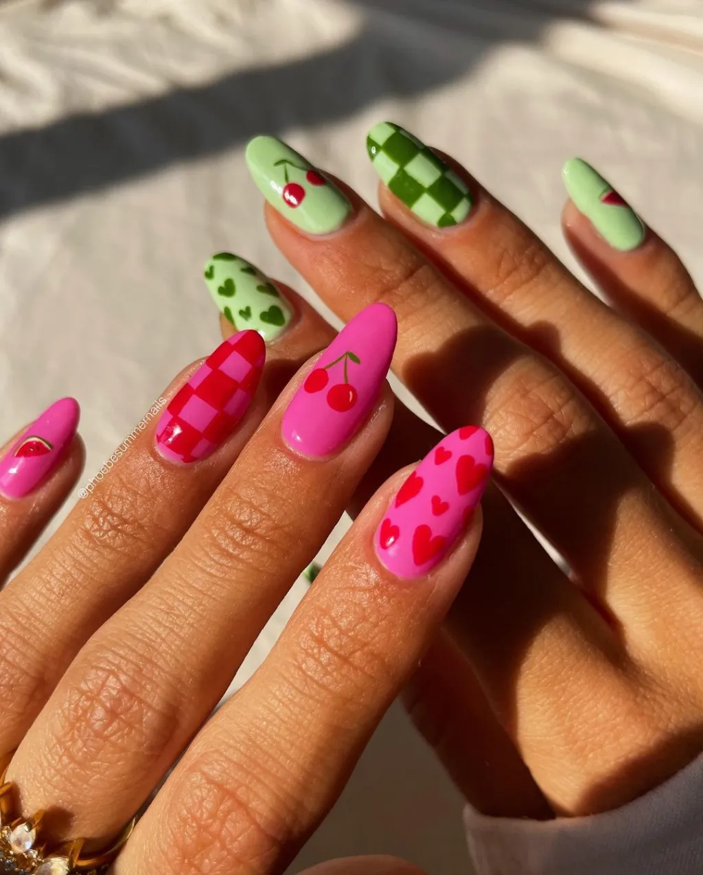 mismatched pink red and green cherry nails with cute checkerboard and heart accent designs