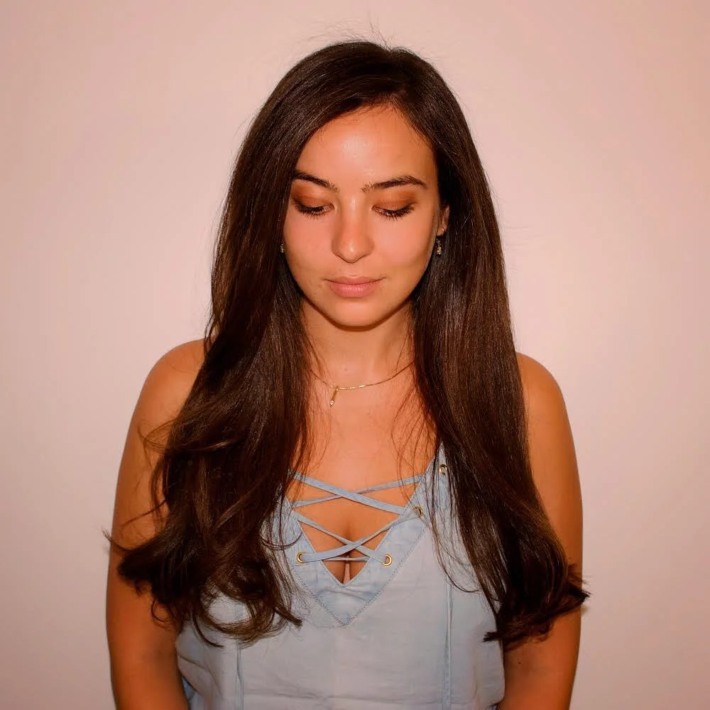 A woman with beautiful long hair styled in a chic, breezy updo perfect for long hair summer hairstyles 2026. The look is elegant yet casual.