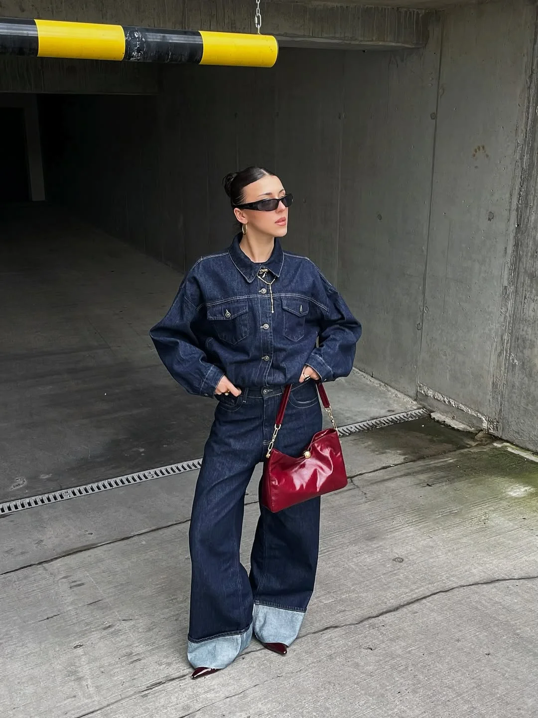 Dark Wash Denim Jumpsuit With Statement Red Bag