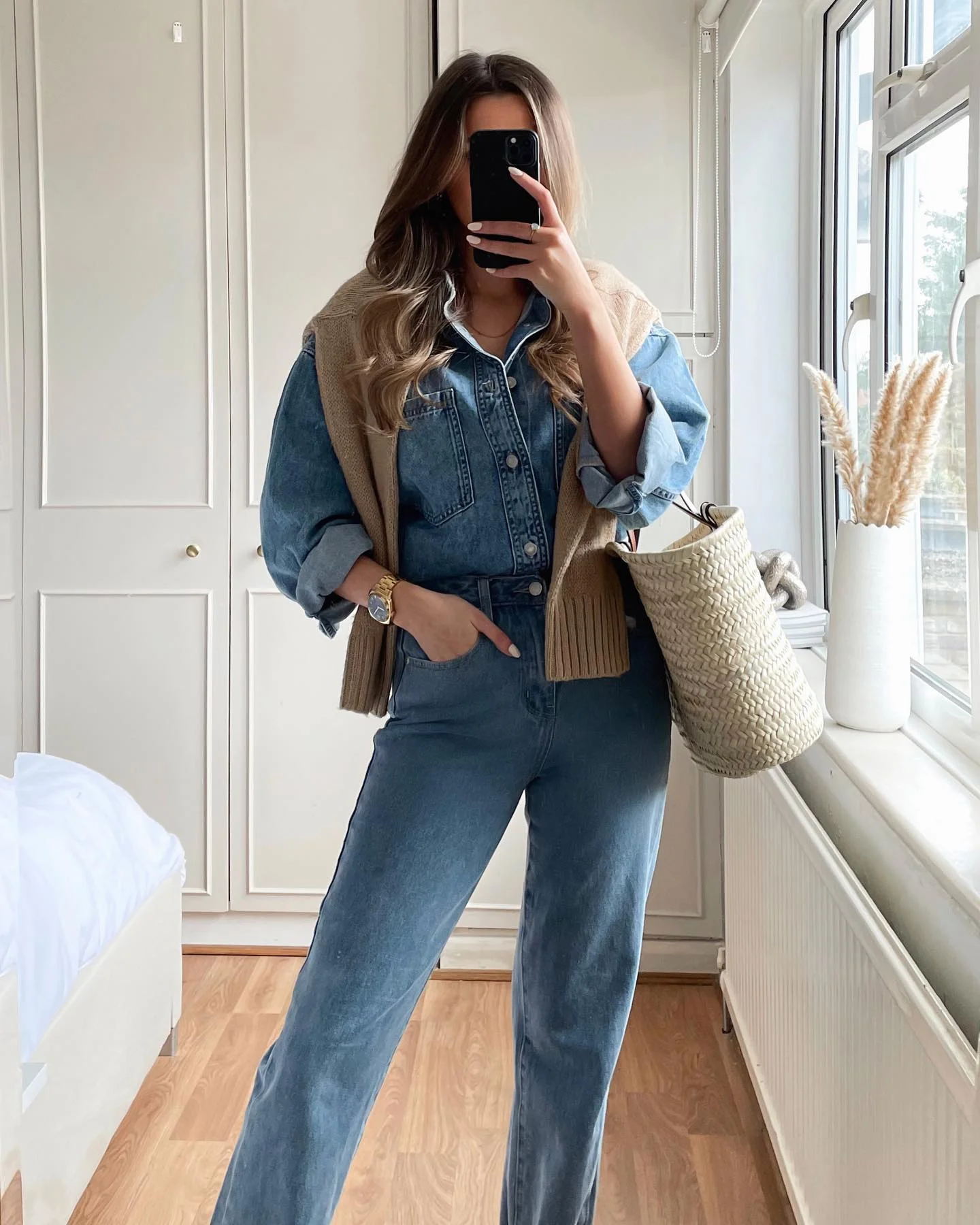 Denim Jumpsuit With Layered Knit And Straw Tote