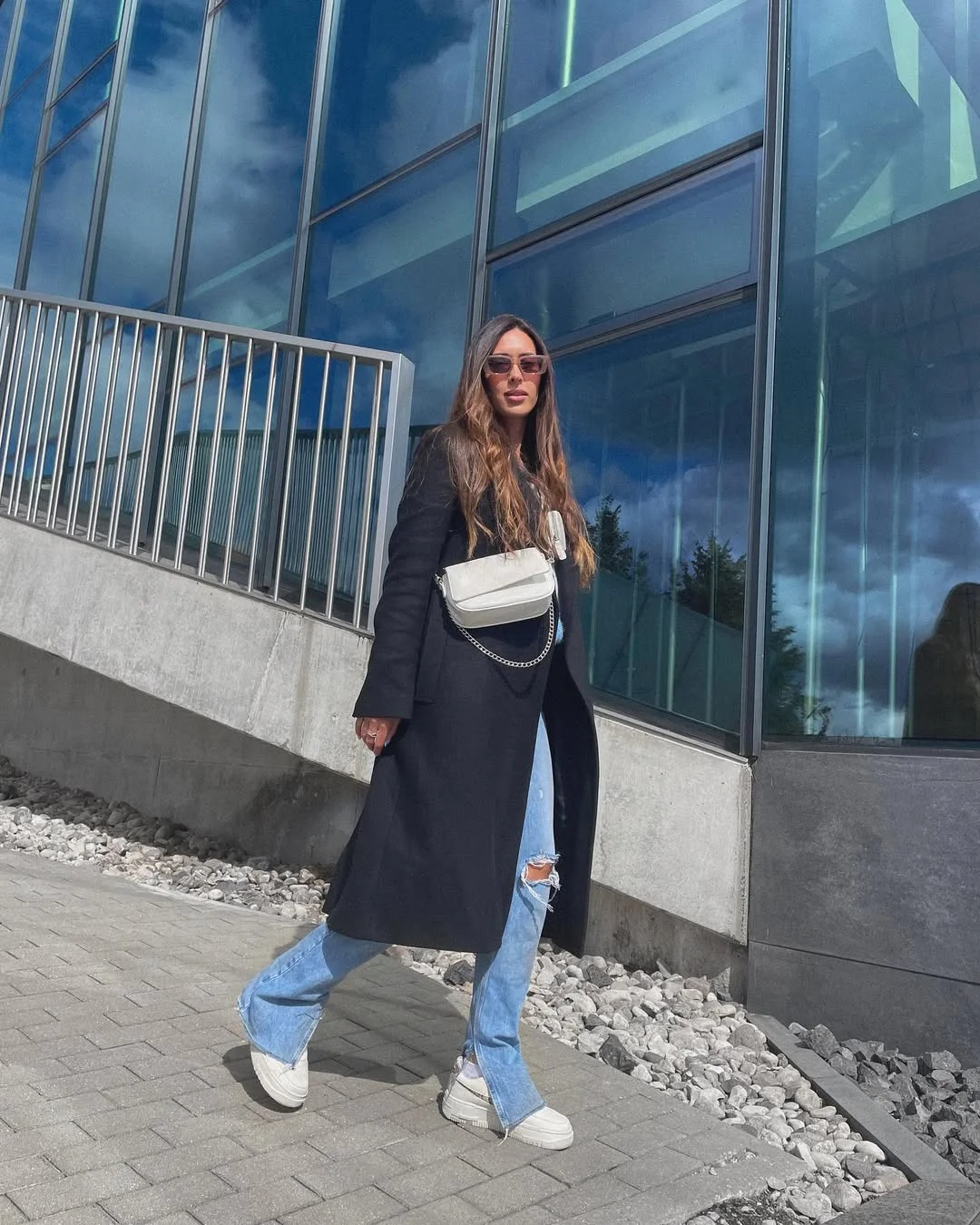 Long Black Coat With Ripped Denim & White Sneakers