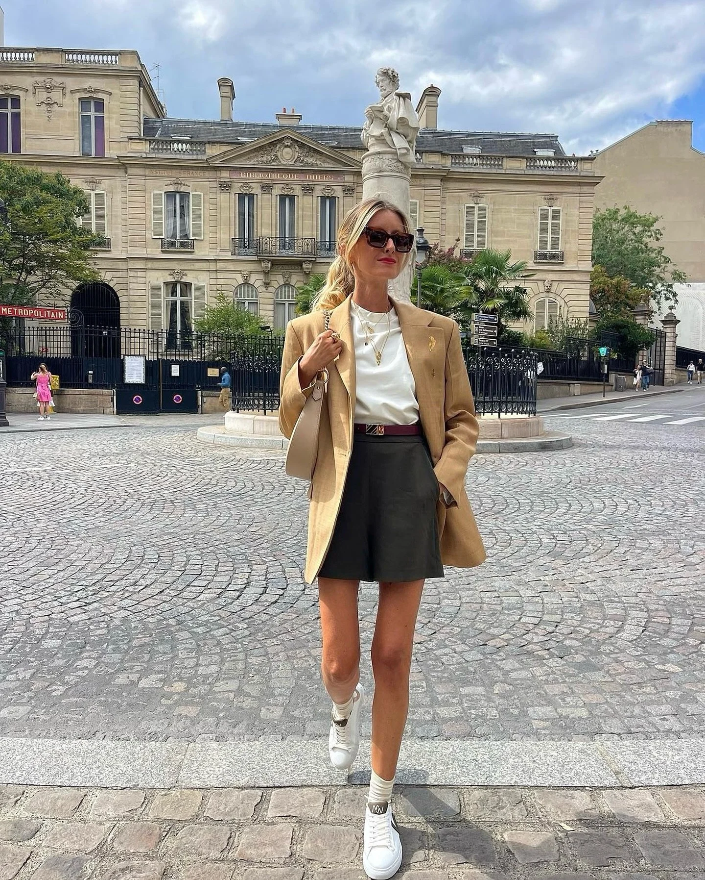 Tan Blazer With Dark Shorts And Sneakers